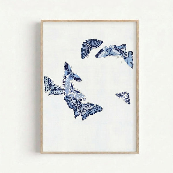 Framed wall art displaying a graceful butterfly rendered in simple navy line work against soft cream, embodying wabi sabi minimalist aesthetic.