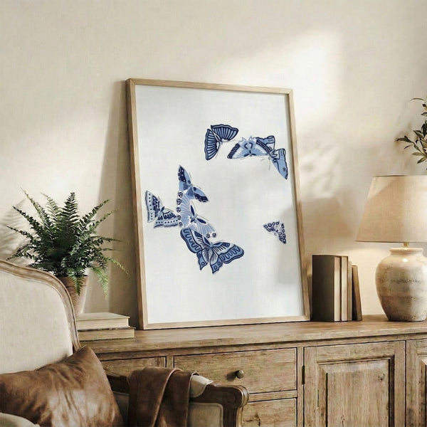Delicate butterfly rendered in indigo linework on cream backdrop, a calm minimalist art print reflecting wabi sabi principles.