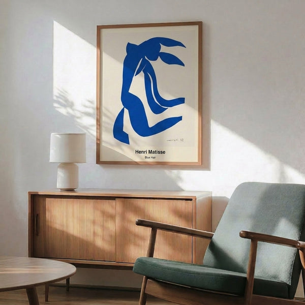 Minimalist abstract artwork depicting a woman's head with distinctive blue hair and ochre tonality, creating an expressive and meditative visual presence.