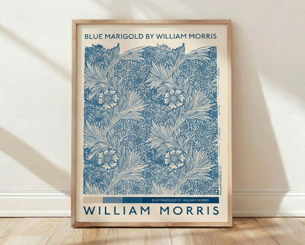 Art Nouveau botanical poster featuring teal and navy marigolds with ornamental leaves on a cream background, framed on a wall.