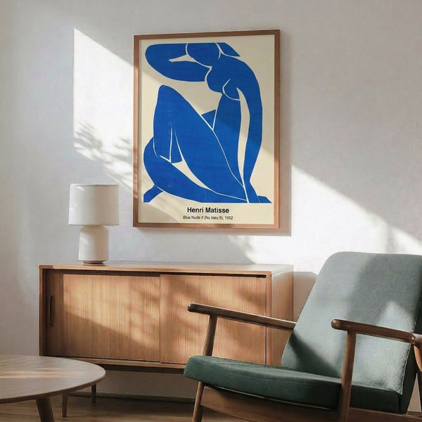 Framed Matisse-inspired abstract artwork displaying a relaxed female form in striking cobalt and white tones with minimalist line work.