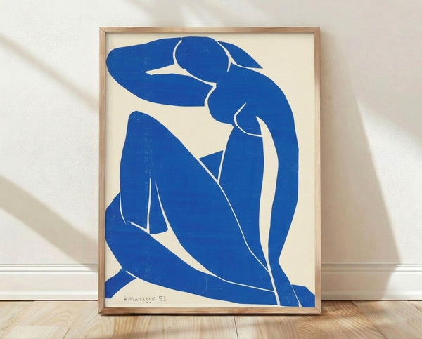 Matisse Blue Nude II framed poster featuring an abstract reclining figure in vibrant cobalt and azure tones against a warm cream background, modernist wall art.