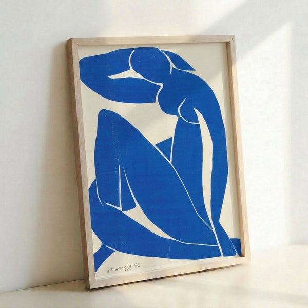 Framed art print of Matisse's iconic Blue Nude II with expressive blue figure and organic shapes on neutral ground, minimalist aesthetic wall decor.