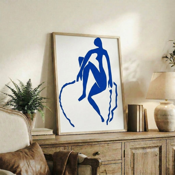 Striking wall art featuring an energetic blue abstracted figure in motion, created through the distinctive cutout technique with bold shapes and pure saturated color.