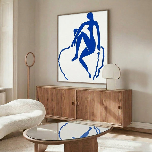 Contemporary framed poster of a leaping blue form with organic curved edges, exemplifying modernist simplification and expressive movement through vibrant color and gestural shape.