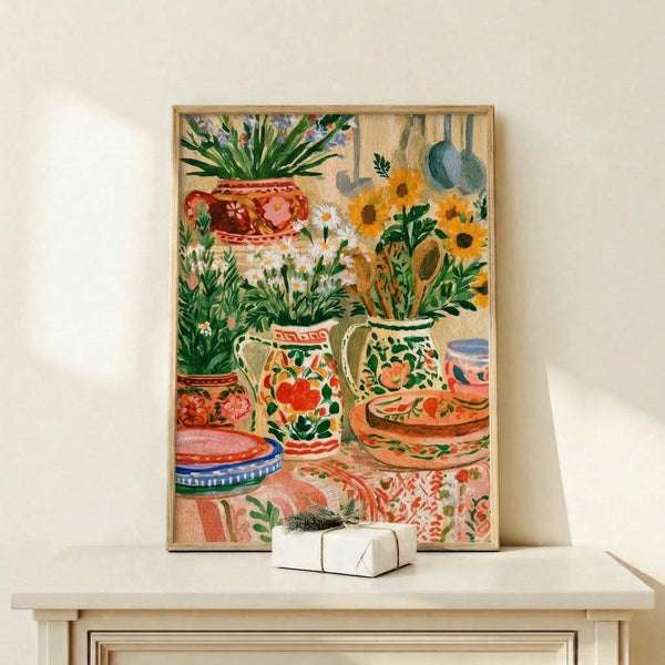 Cottagecore watercolor art print showing an arrangement of cacti, sunflowers, and terracotta pottery with foliage in coral pink, cream, and earthy green hues, displayed as a framed poster.