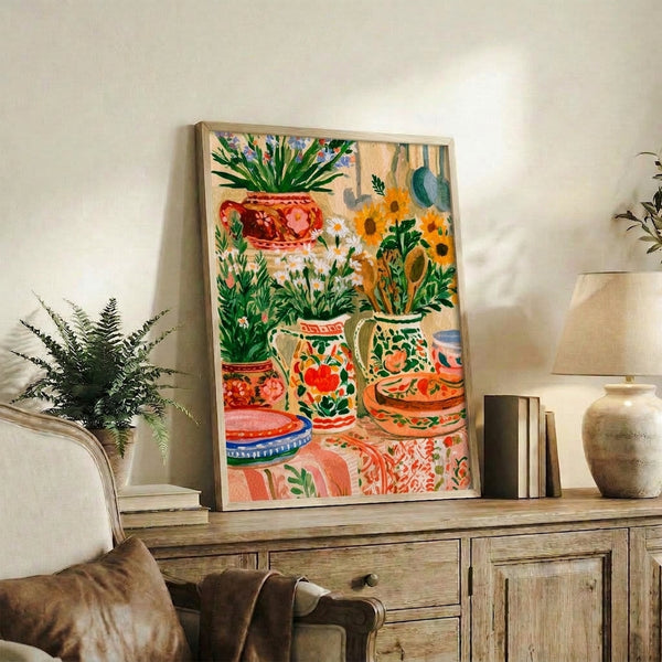 Warm, cheerful boho kitchen still life watercolor painting with sunflowers, ceramic bowls, vases, and potted plants in golden yellow, terracotta red, and forest green, framed wall art.