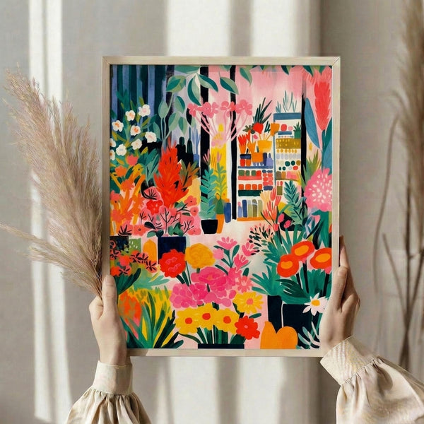 Framed mid-century modern botanical print featuring an indoor garden scene with vibrant flowers, leafy plants, and a figure in Bauhaus style with warm coral, emerald, and cream palette.