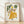 Watercolor painting of a whimsical woman with a lemon head wearing a flowing kimono adorned with botanical motifs, framed poster in bohemian style with warm yellow, green, and cream tones.