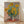 Impressionist painting of a vibrant bouquet of sunflowers in warm yellows and golds, displayed as a framed poster on a wall.