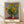 Impressionist painting of a radiant sunflower bouquet in a vase, rendered in luminous golden yellows and soft greens with blue-grey accents, creating a warm and serene floral composition.