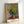 Golden sunflowers arranged in a vase, painted in soft Impressionist style with warm yellows, gentle greens, and muted blue-grey tones that convey tranquility and natural luminosity.