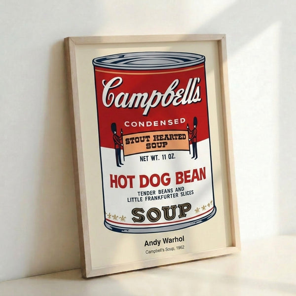Framed modern pop art print of a Campbell's soup can label, combining ironic commentary on mass production with vibrant red and metallic gold tones.