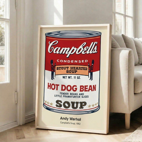 Andy Warhol's soup can artwork displayed as a framed poster, exemplifying pop art with its bold graphic simplification and striking red palette.