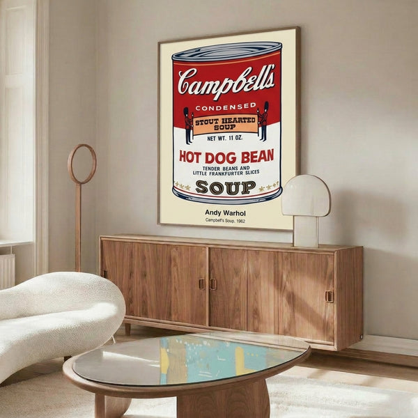 Pop art poster featuring Warhol's deadpan Campbell's soup can design with gold and red accents, a critique of commercial culture and mass production.