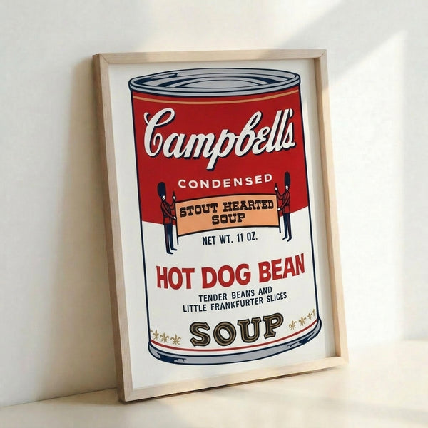 Framed poster of a classic Campbell's tomato soup can with bold graphic design, rendered in striking red and white pop art colors.