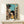 Kawaii anime art print showing a girl with a black cat in a whimsical urban alley, blending pale yellows, creams, and rust tones with classic Showa period charm.