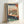 Framed poster showcasing an intimate moment of a cat watching nature from indoors, featuring indigo, cream, and terracotta hues in classic Japanese aesthetic.