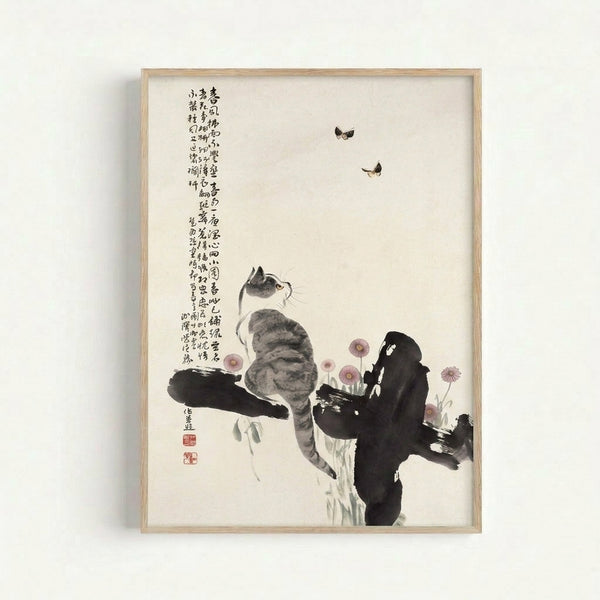 Minimalist art print on wall showing a serene cat with butterflies and blossoms in soft grays and pinks, inspired by ukiyo-e traditions.