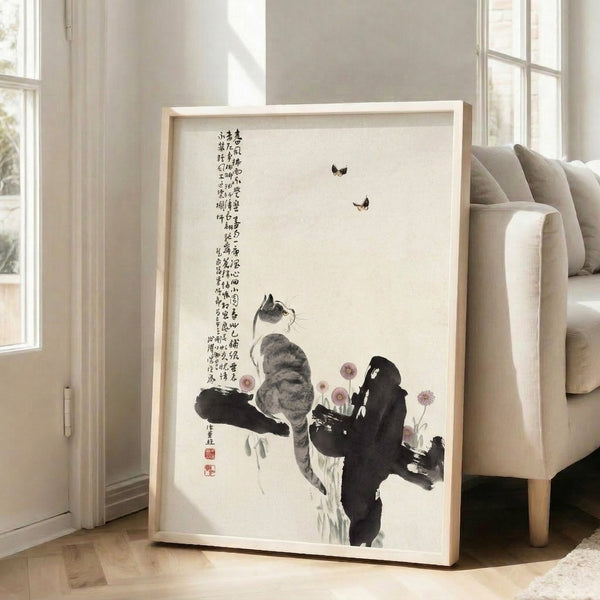 Wall-mounted poster with a poised cat and fluttering butterflies among graceful branches, combining minimalist design with traditional Asian art sensibilities.