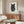 Black line art poster of a cat silhouette intertwined with fingerprint pattern, cream backdrop, modern minimalist composition.