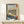 Japanese art print with a cat silhouetted against a window frame, gazing toward Fuji with birds and flowers in the landscape, executed in warm rust and cool blue tones.
