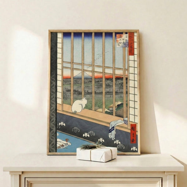 Japanese art print with a cat silhouetted against a window frame, gazing toward Fuji with birds and flowers in the landscape, executed in warm rust and cool blue tones.