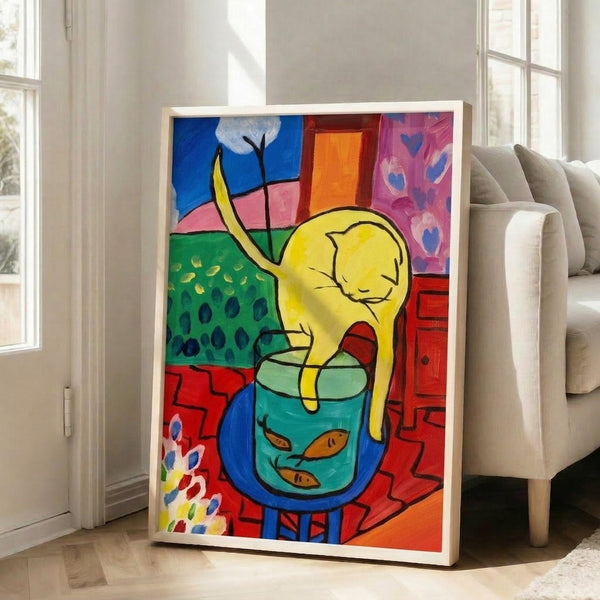 Framed artwork showing a tuxedo cat with an alert expression fixed on a brilliant red fish, combining flat color planes and dynamic composition.