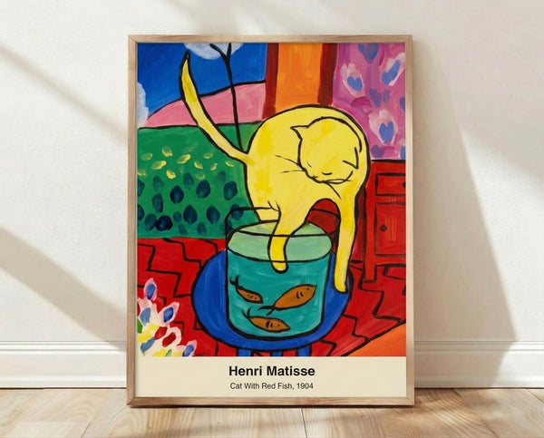 Framed poster of a tuxedo cat gazing at a red fish in a gold bowl, rendered in vibrant impressionist style with bold blues, oranges, and greens creating a whimsical domestic scene.