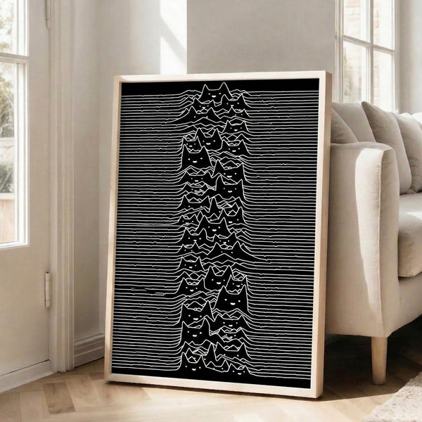 Minimalist framed artwork combining a quirky cat form with abstract mountain and wave line patterns in bold black and white tones.