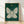 Framed line art poster of a delicate moth with spread wings centered against a starry night sky, moon phases, and celestial elements in forest green, gold, and cream on a teal background, creating a peaceful and mystical cottagecore aesthetic.