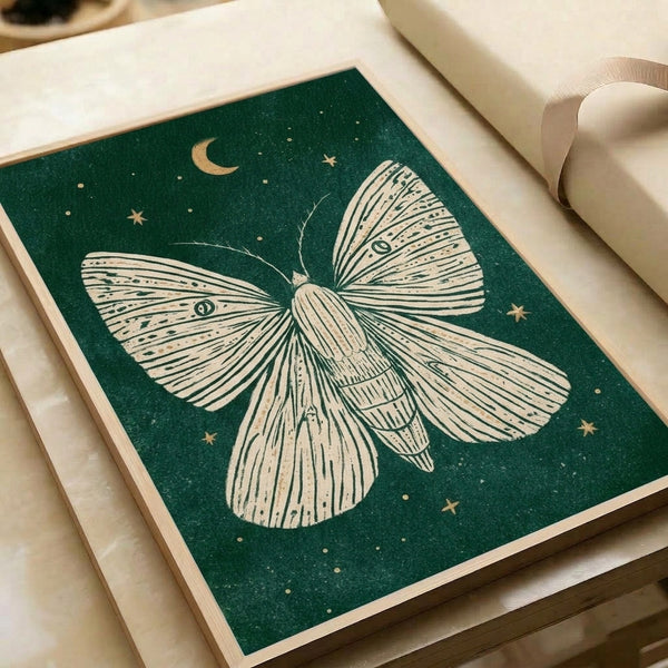 Framed poster displaying a graceful moth rendered in elegant line work, floating among constellations and moon cycle symbols in a calming palette of forest green, cream, and teal with golden accents.