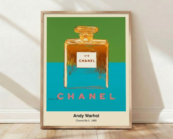 Bold pop art print featuring a stylized Chanel No. 5 perfume bottle in red, gold, and black on white background, displayed as framed wall art.
