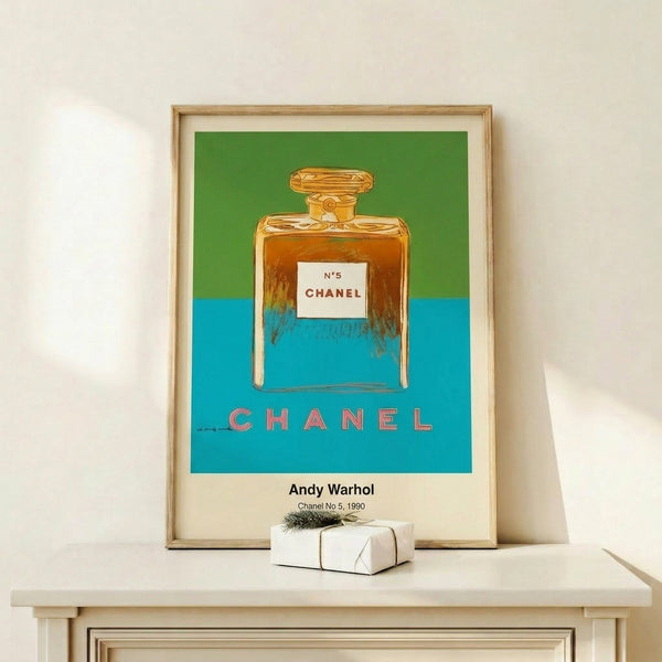 Iconic pop art print of a Chanel No. 5 bottle rendered in rich reds and golds against contrasting white, framed and hung as contemporary wall art.