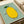 Playful lemon fruit illustration in minimalist folk art with black line work, yellow and soft green tones creating cheerful kitchen wall decor.