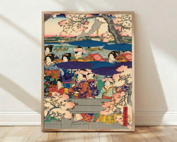 Framed Japanese woodblock print depicting an elegant geisha in a boat beneath cherry blossoms, rendered in soft pink, blue, and gold tones with serene, festive mood.