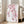 Soft watercolor illustration of flowering cherry branches with pale pink blooms and sage green foliage in a minimalist Japanese aesthetic.