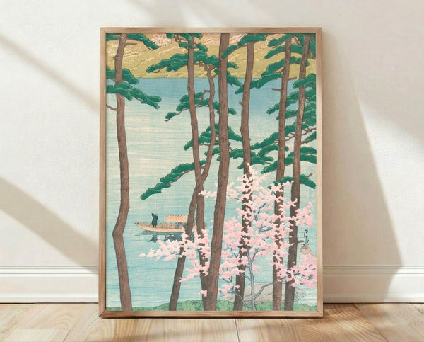 Japanese woodblock-style framed poster of a serene lake landscape with cherry blossoms, tall pine trees, and a small boat, rendered in soft pink, sage green, and pale blue tones.