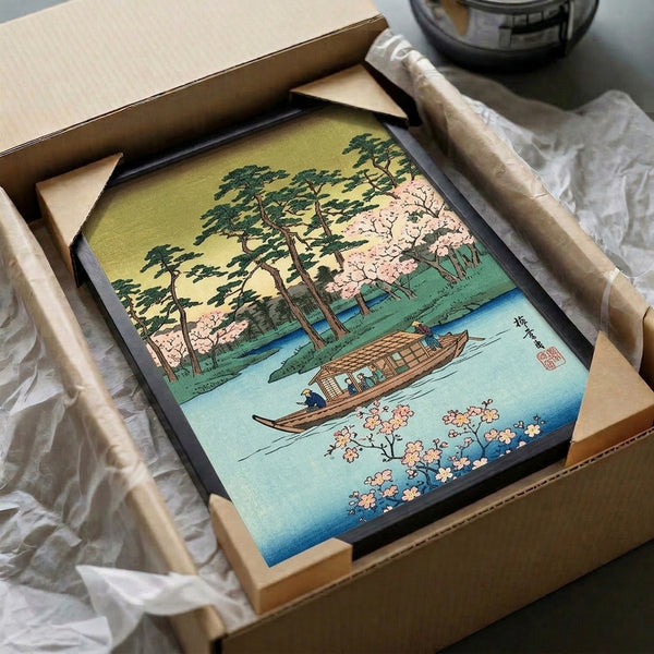 Framed art print with serene lake and landscape motifs including cherry blossoms, evergreen trees, and a boat rendered in gentle Japanese woodblock style with soft blue, pink, and sage green palette.
