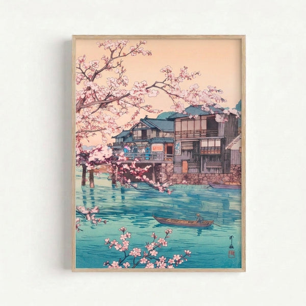 Contemplative ukiyo-e art print showing a riverside scene with blooming sakura trees, a wooden structure, and a boat on calm turquoise waters in muted pink and charcoal hues.