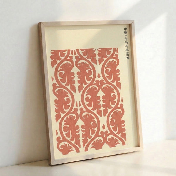 Cream and terracotta red Japanese woodblock print displaying an intricate classical textile pattern with flowing scroll ornaments in an orderly arrangement.