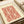 Framed art print in terracotta red and cream displaying a symmetrical Japanese woodblock textile pattern with classical scroll and decorative tile elements.
