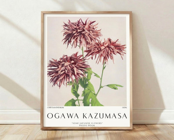 Framed botanical art print of a delicate chrysanthemum flower with burgundy and mauve petals, green stems and leaves on a cream background in Impressionist style.