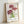 Serene Impressionist chrysanthemum artwork framed on wall, showcasing layered petals in mauve and pale pink with graceful green foliage against a cream backdrop.