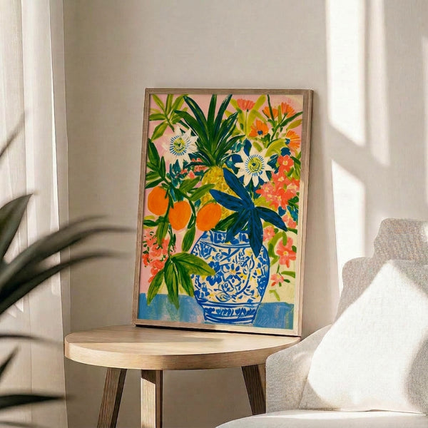 Boho watercolor art print displaying an abundant floral arrangement of orange blossoms and pink passionflowers in a blue and white ceramic vase with lush green leaves.