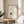 Peaceful wabi sabi coffee art with minimalist kettle and cup line drawing in cream and black on wall.