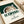 Contemporary halftone artwork of a coffee latte cup in cream, brown, and forest green tones, reflecting modern minimalist design sensibilities.