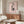 Contemporary framed print with spare black linework depicting human figures against blush pink and cream, expressing subtle emotional depth.