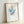 Framed poster art displaying stylized faces in saturated pop art colors, creating a striking gallery-worthy wall hanging.