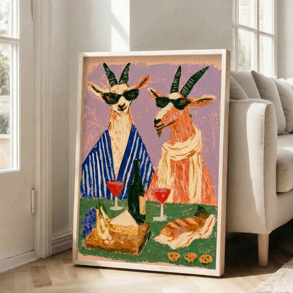 Quirky boho-inspired framed art print of a sophisticated goat enjoying wine and cheese at a picnic, rendered in warm retro colors with a playful, leisurely mood.